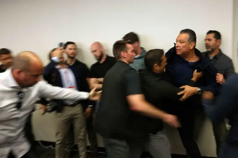 مشهد من اعتقال أحد القادة المنتخبين أثناء احتجاج، حيث يتدخل رجال الأمن بشكل عنيف في موقف يعكس التوترات السياسية الحالية.