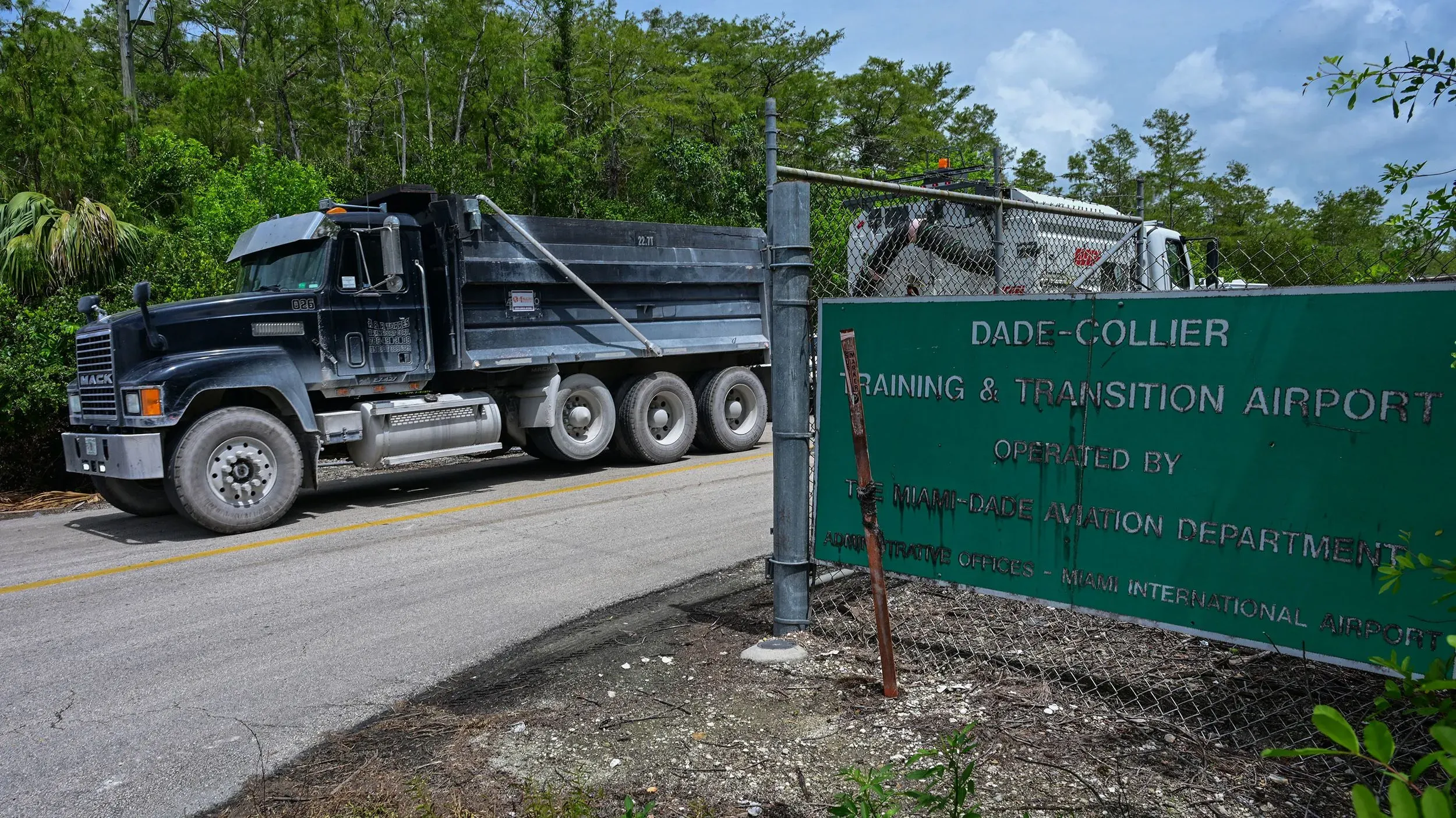 شاحنة كبيرة تمر بجانب مدخل مطار دايد-كولير للتدريب والانتقال، حيث يُبنى مركز احتجاز المهاجرين الجديد في إيفرجليدز.