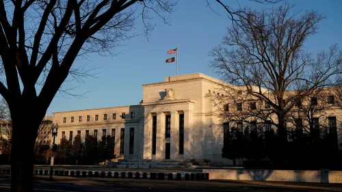 مبنى الاحتياطي الفيدرالي في واشنطن، يظهر العلم الأمريكي، مع التركيز على أهمية استقلالية البنك المركزي في السياسة النقدية.