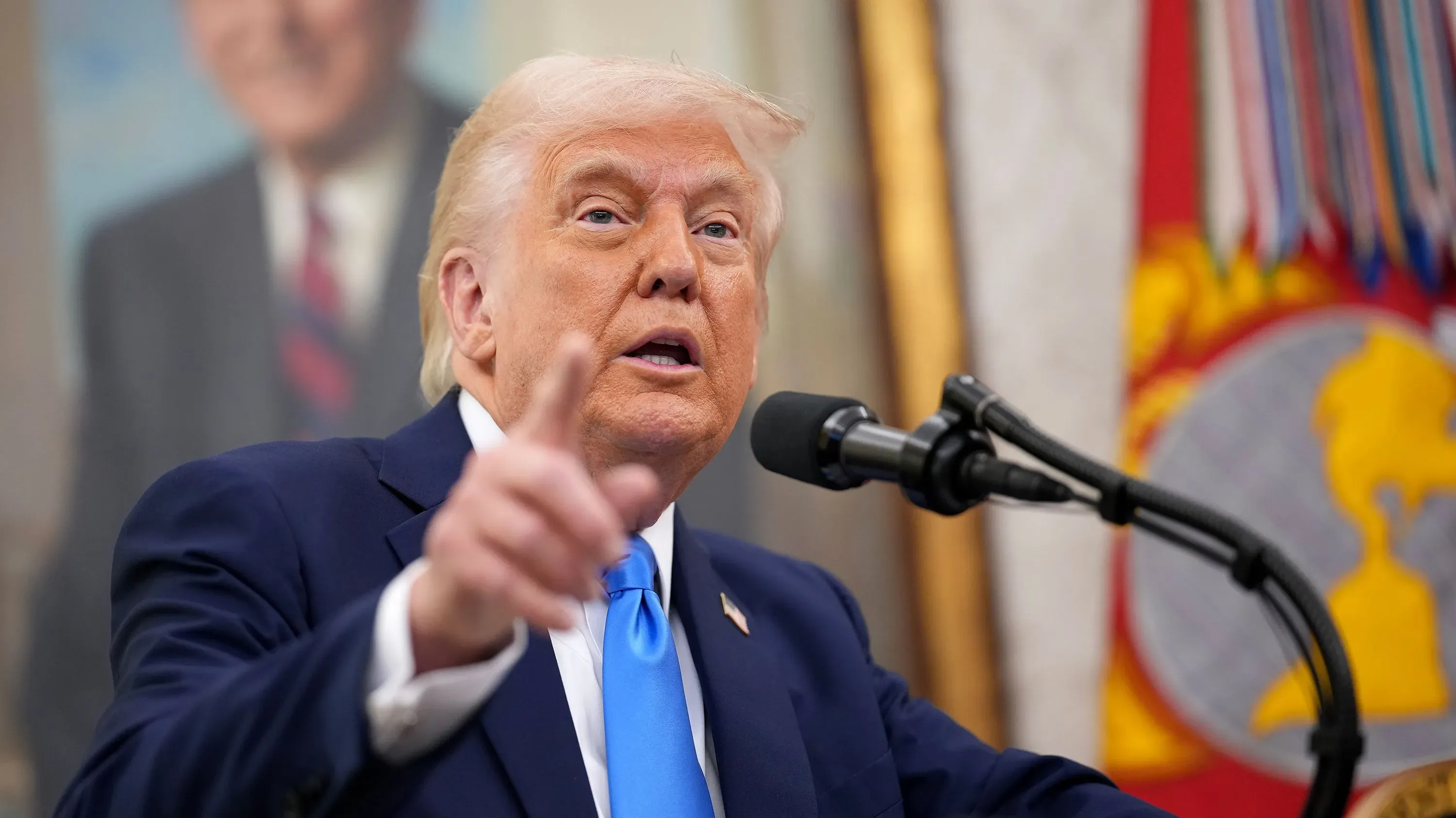 خطاب ترامب في حديقة الورود، حيث يتحدث عن الرسوم الجمركية الجديدة على الواردات. الخلفية تحتوي على أعلام وشعارات رسمية.