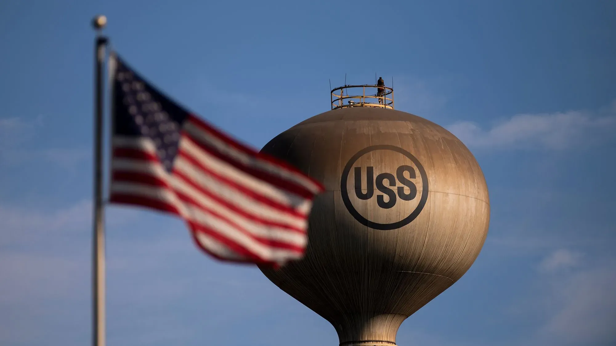 برج مياه يحمل شعار شركة يو إس ستيل، مع العلم الأمريكي يرفرف بجانبه، في سياق صفقة الاستحواذ المثيرة للجدل.