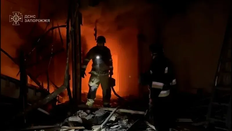 رجال إطفاء يعملون على إخماد حريق في مبنى مدمر بأوديسا، مع تصاعد ألسنة اللهب والدخان بعد هجوم بطائرة مسيرة.