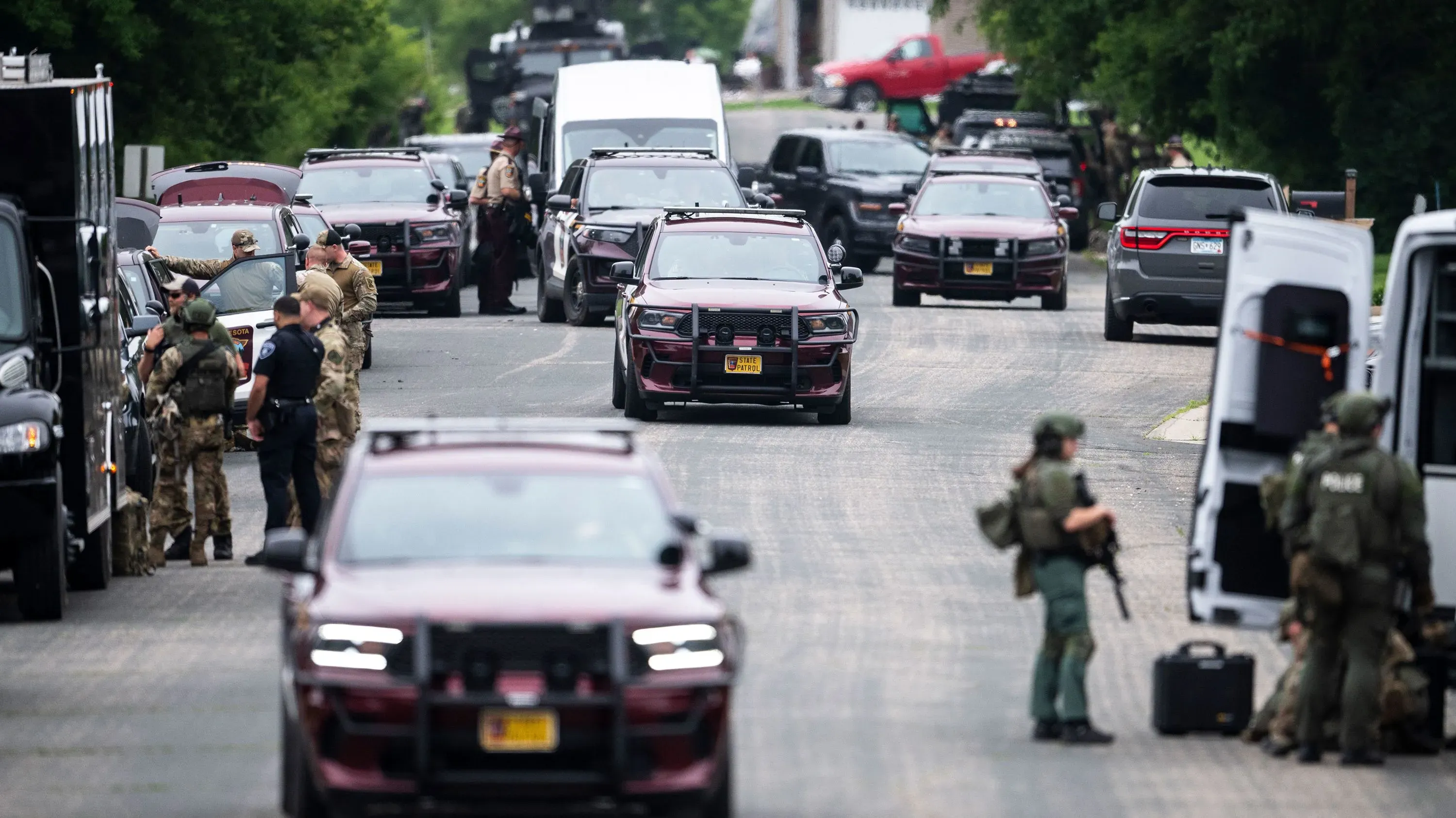 تواجد كثيف لقوات الأمن والمركبات الرسمية في موقع حادث إطلاق نار، حيث يعكس الأجواء المتوترة بعد الحادث المأساوي في مينيسوتا.